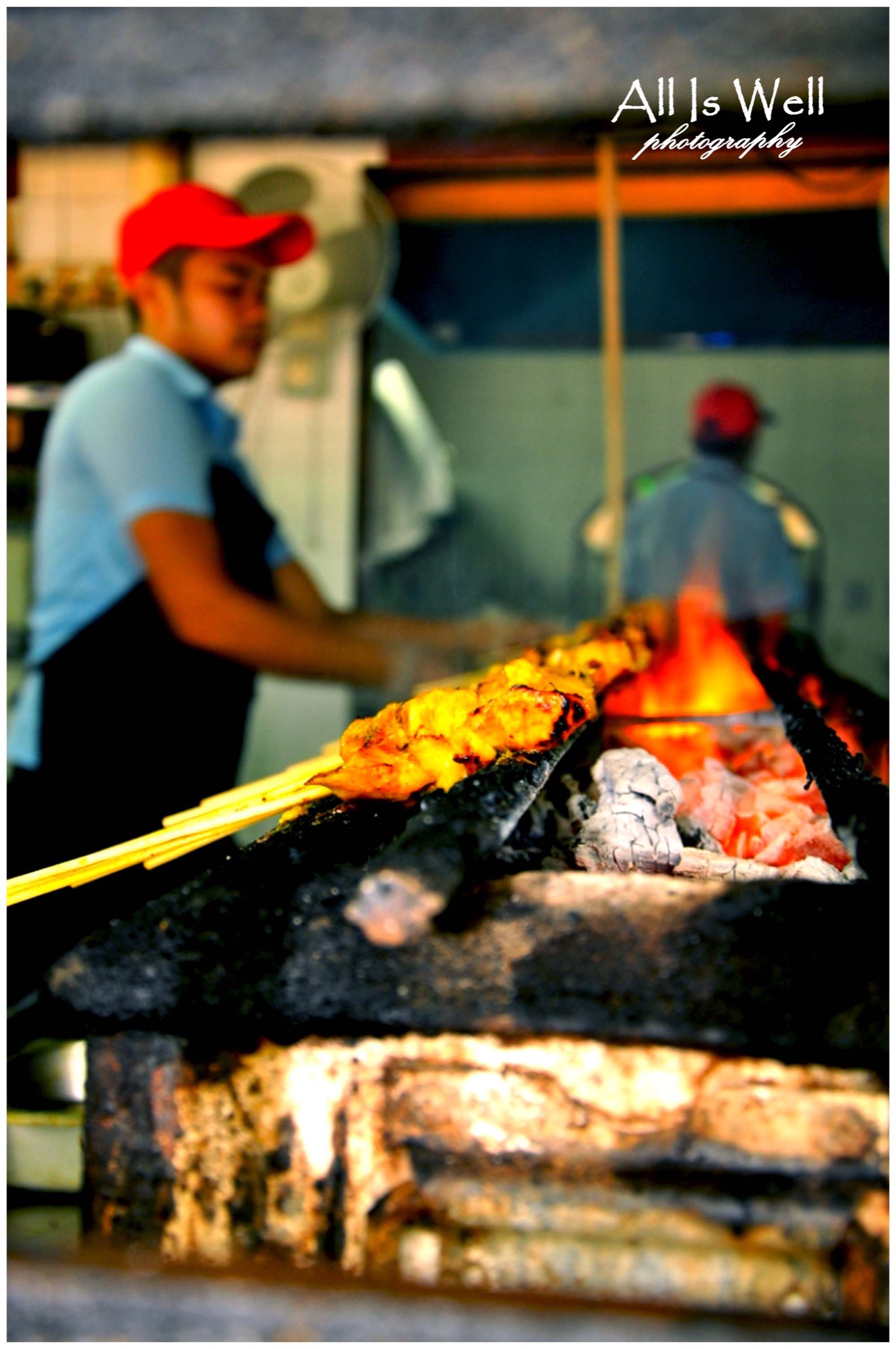 Satay being grilled over hot coals