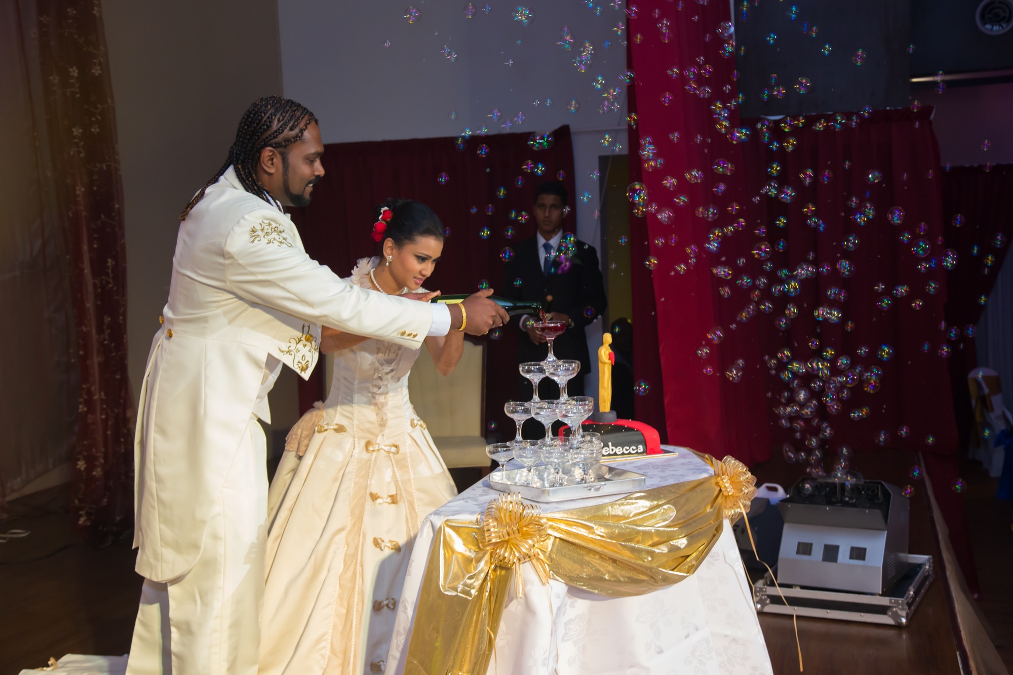 Couple pouring champagne as bubbles fill the air